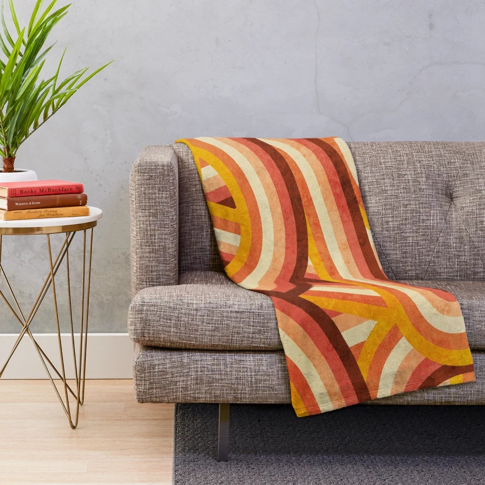 Vintage-inspired plush blanket with vibrant rainbow stripes in a retro 70s style