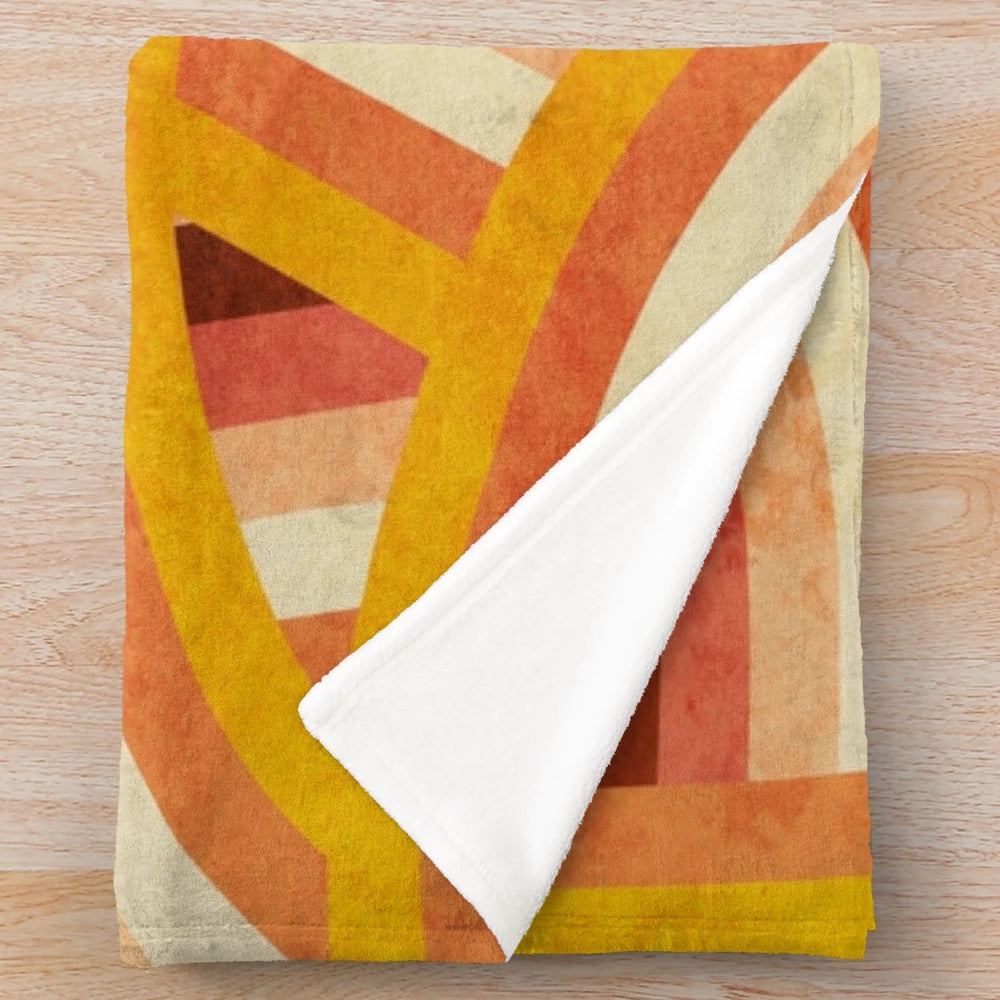 Vintage-inspired plush blanket with vibrant rainbow stripes in a retro 70s style