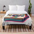 Vibrant plush blanket with classic 80s polaroid camera design
