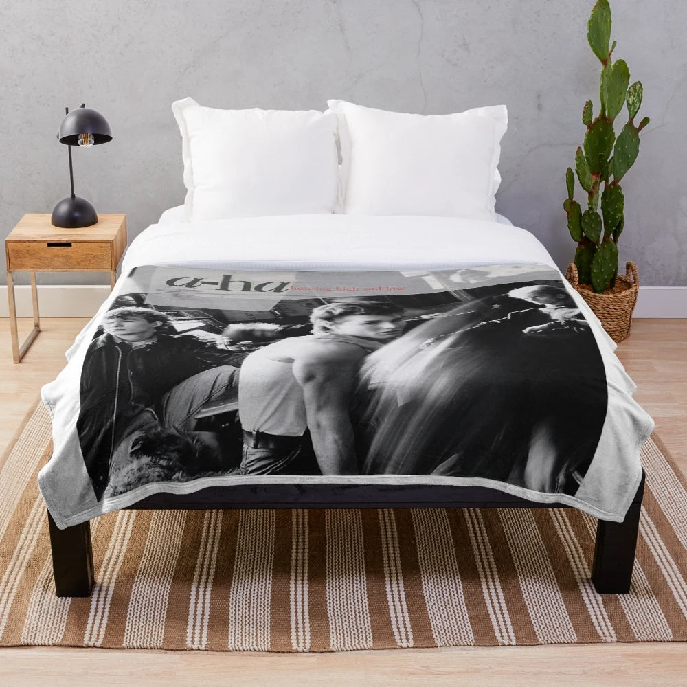 Soft and cozy plush blanket featuring the iconic A-ha band and 'Hunting High and Low' album art