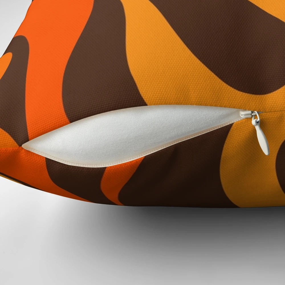 Retro abstract pattern in 70s orange and brown colors on a decorative pillow