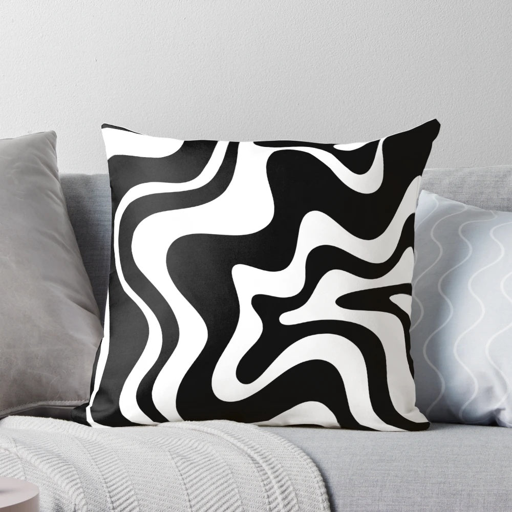 Decorative abstract swirl pattern black and white throw pillow for modern, boho, or minimalist home decor.
