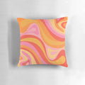 Vibrant retro abstract pattern design on a pink, orange, and yellow throw pillow.