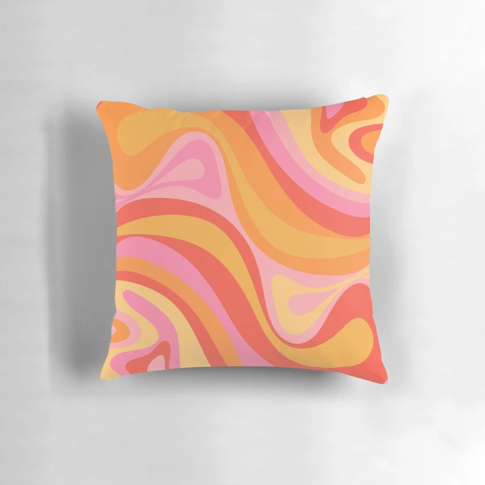 Vibrant retro abstract pattern design on a pink, orange, and yellow throw pillow.