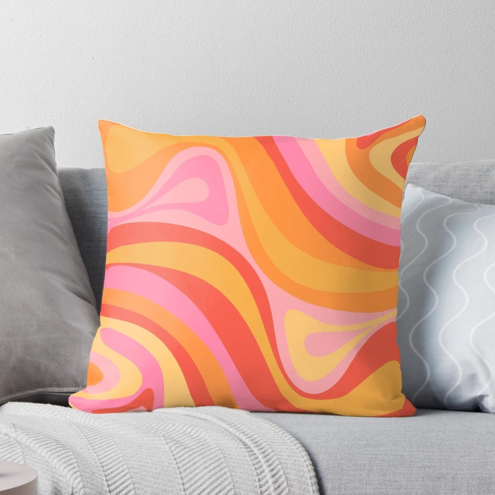 Vibrant retro abstract pattern design on a pink, orange, and yellow throw pillow.