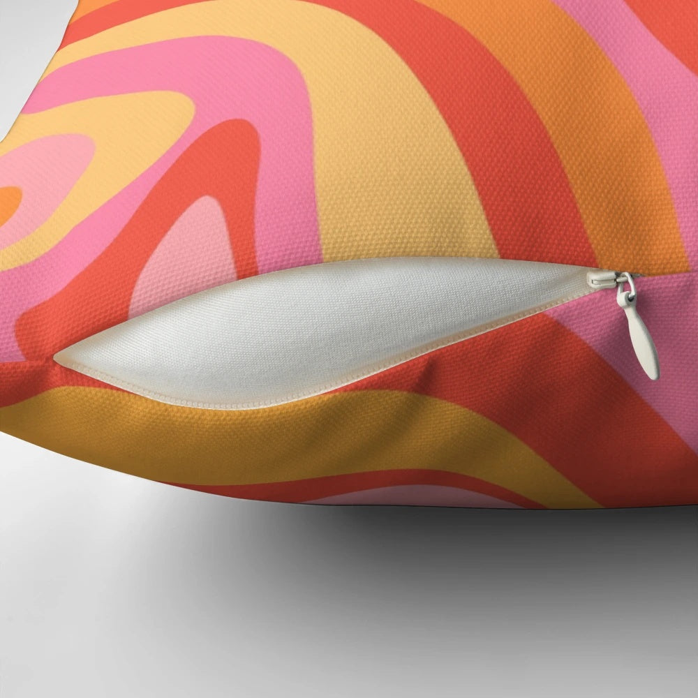 Vibrant retro abstract pattern design on a pink, orange, and yellow throw pillow.