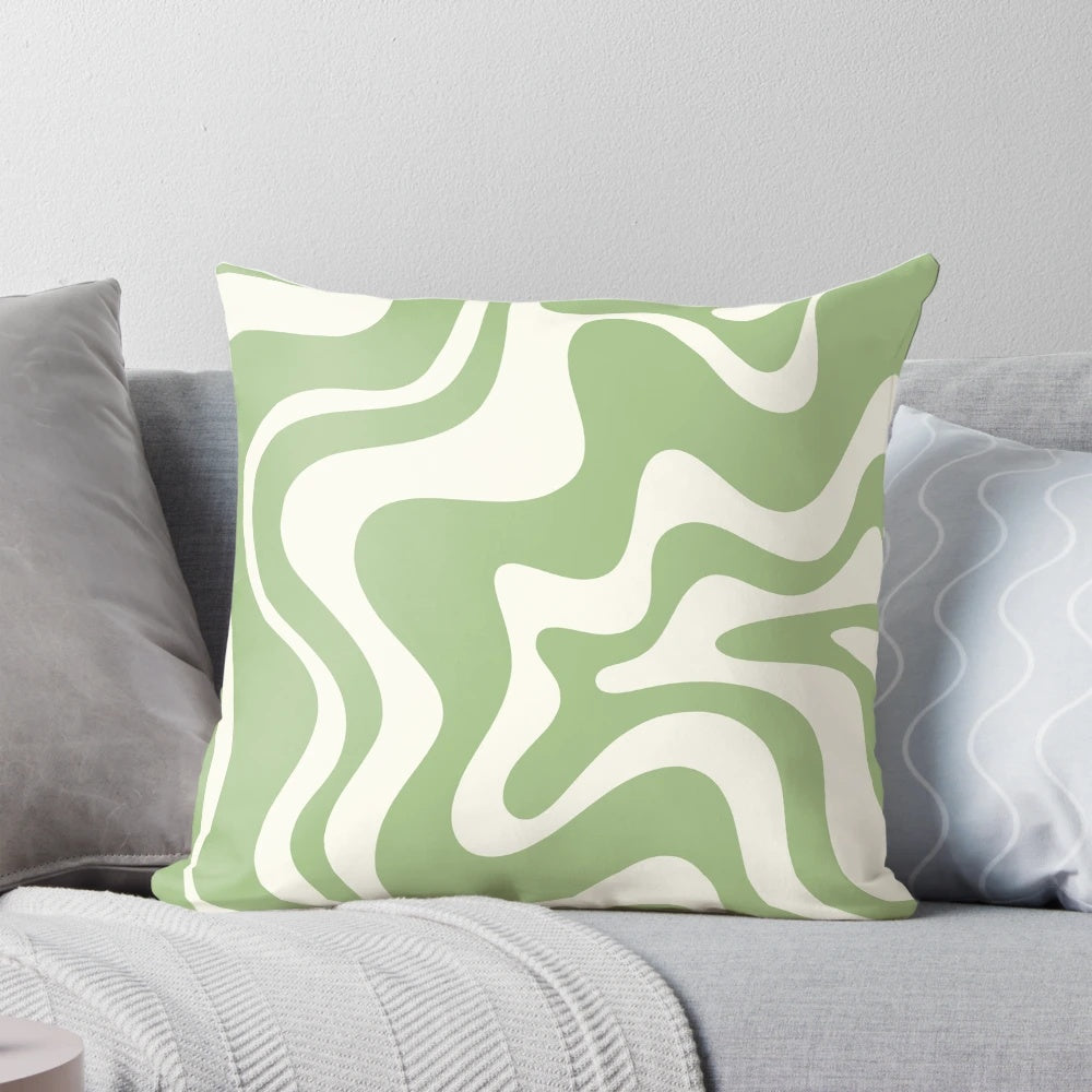 Retro abstract swirl pattern pillow in light sage green and cream colors