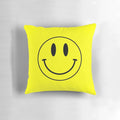 Vibrant yellow smiley face pillow with retro acid house design