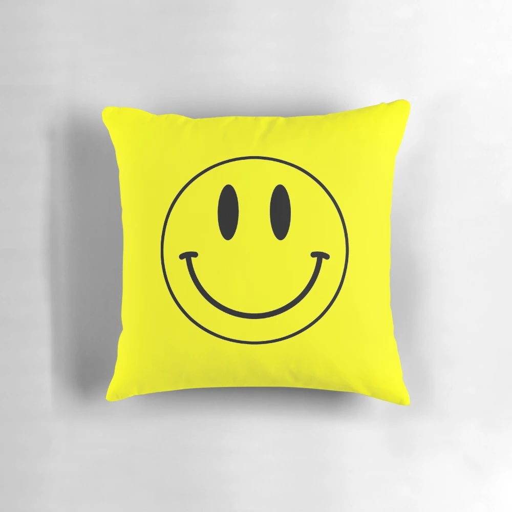 Vibrant yellow smiley face pillow with retro acid house design