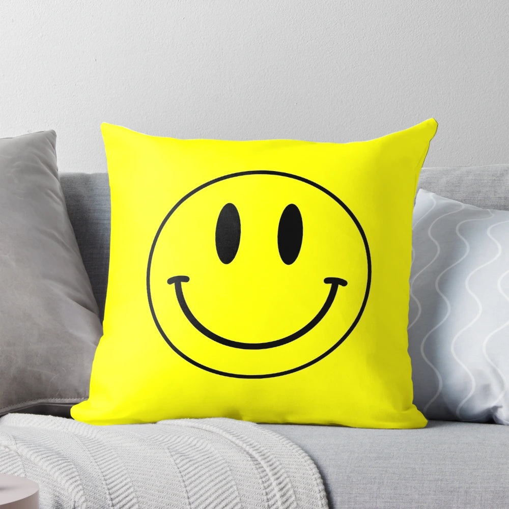 Vibrant yellow smiley face pillow with retro acid house design