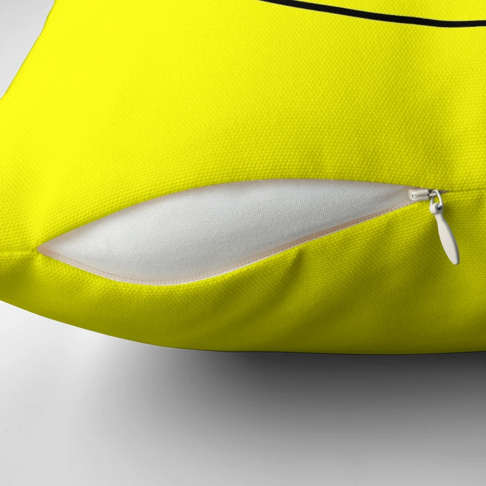 Vibrant yellow smiley face pillow with retro acid house design