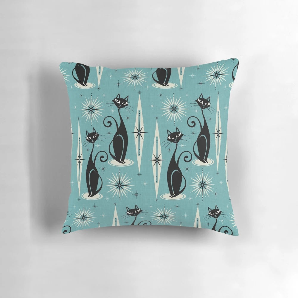Mid-century modern blue pillow with a black and gray atomic cat design and starburst pattern