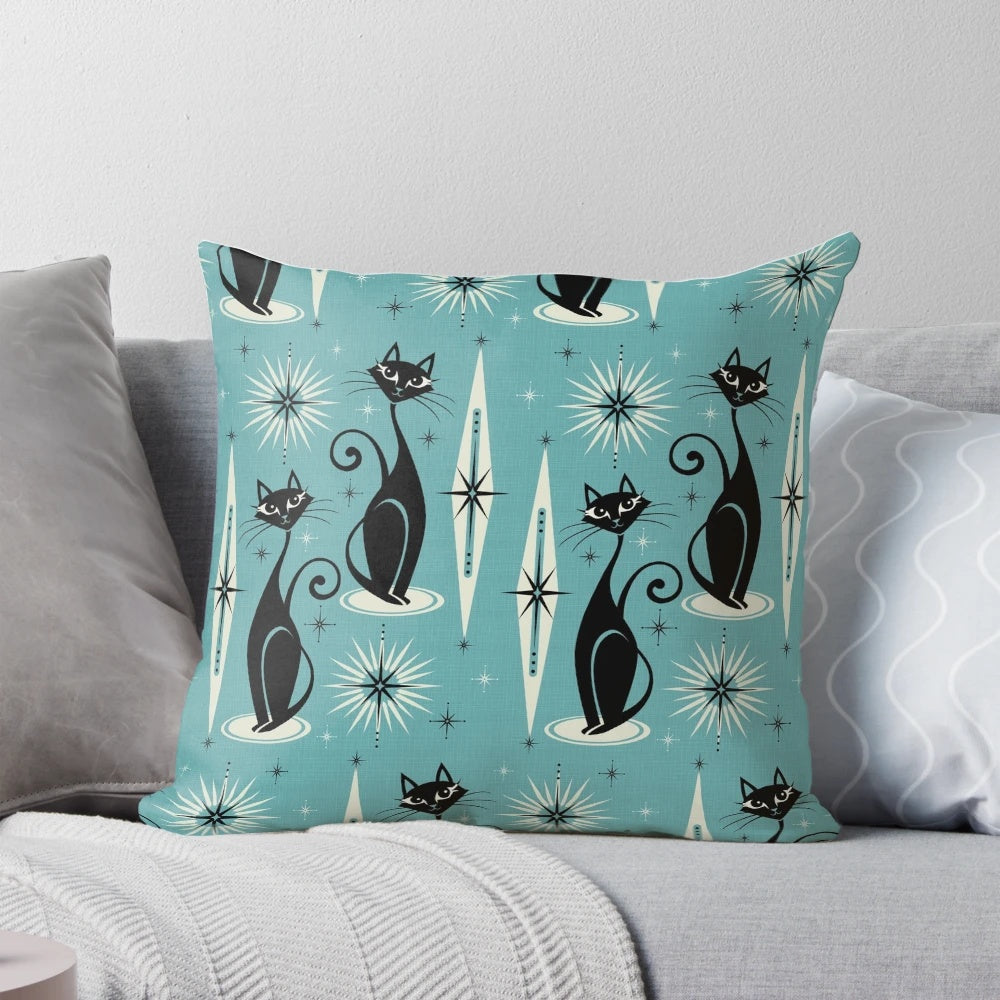 Mid-century modern blue pillow with a black and gray atomic cat design and starburst pattern
