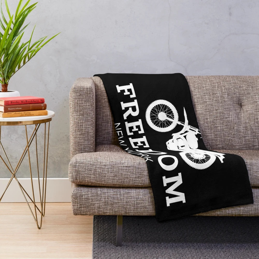 Plush blanket featuring a vintage-style illustration of a person riding a bicycle in New York City