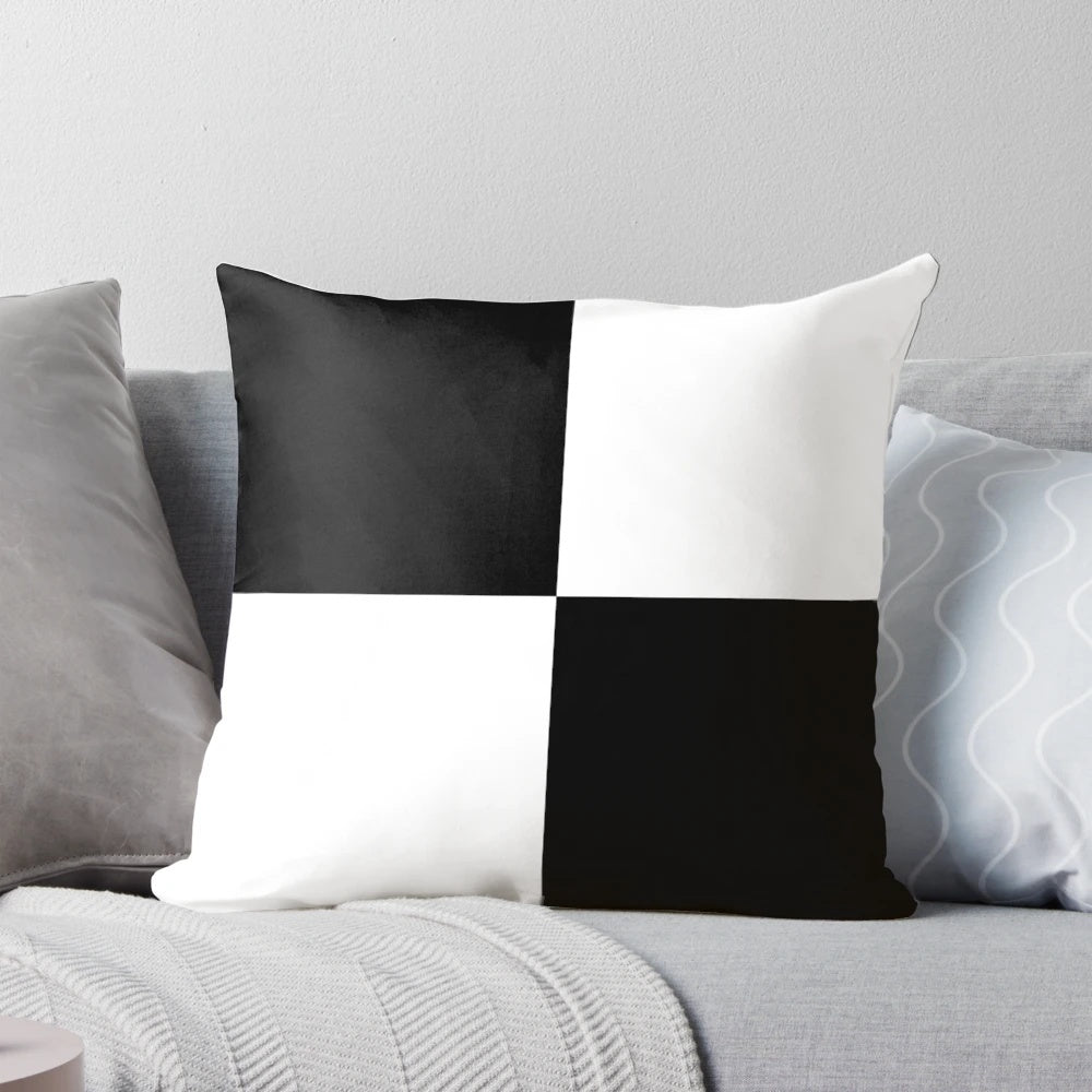 Black and white pillow with geometric checkered pattern and contrasting blocks