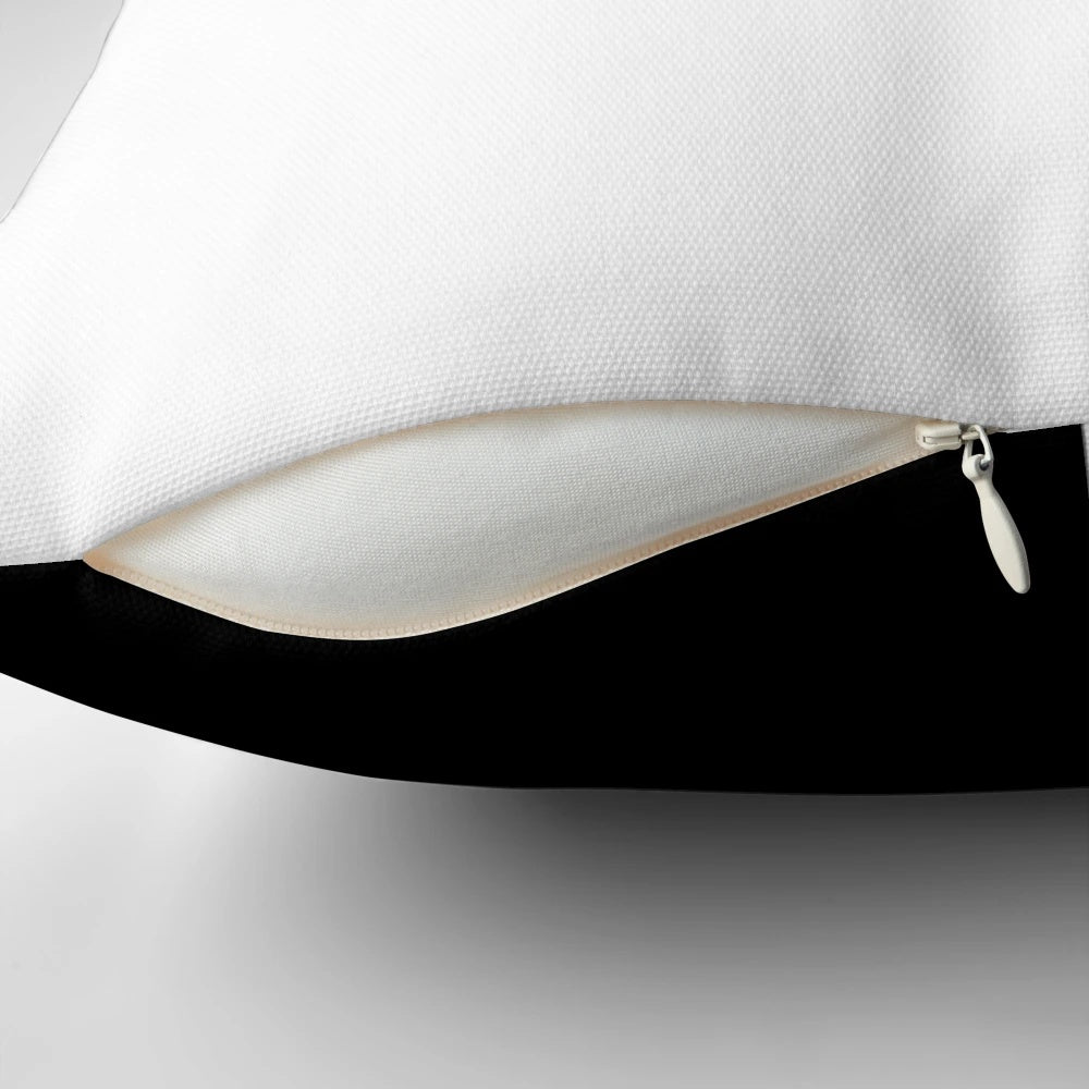 Black and white pillow with geometric checkered pattern and contrasting blocks