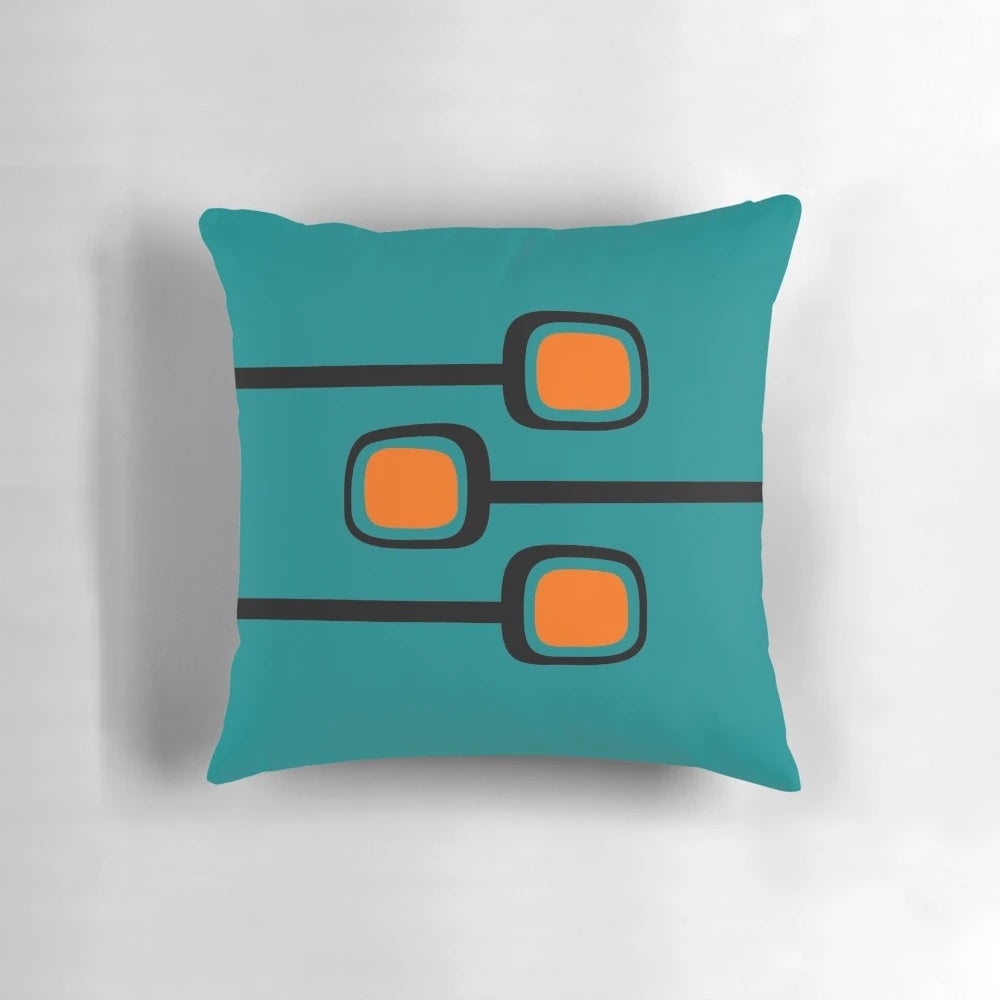 Retro mid century modern throw pillow with black and orange branches on a teal background