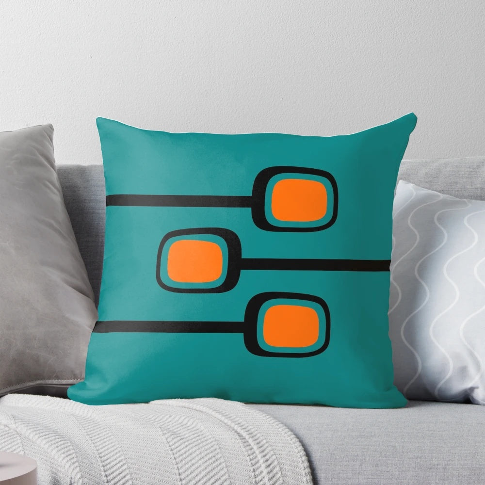 Retro mid century modern throw pillow with black and orange branches on a teal background