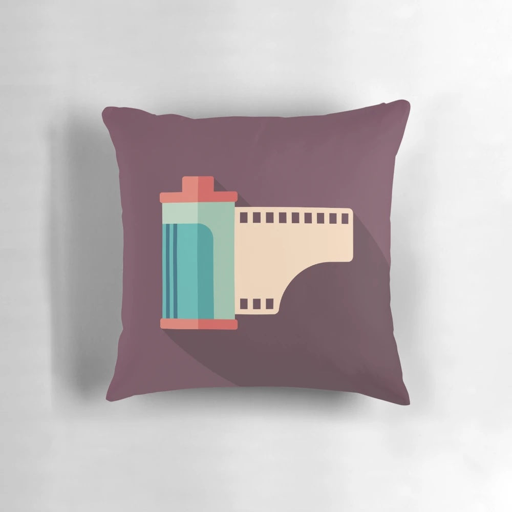 A pillow featuring a retro camera roll design, perfect for photography enthusiasts.