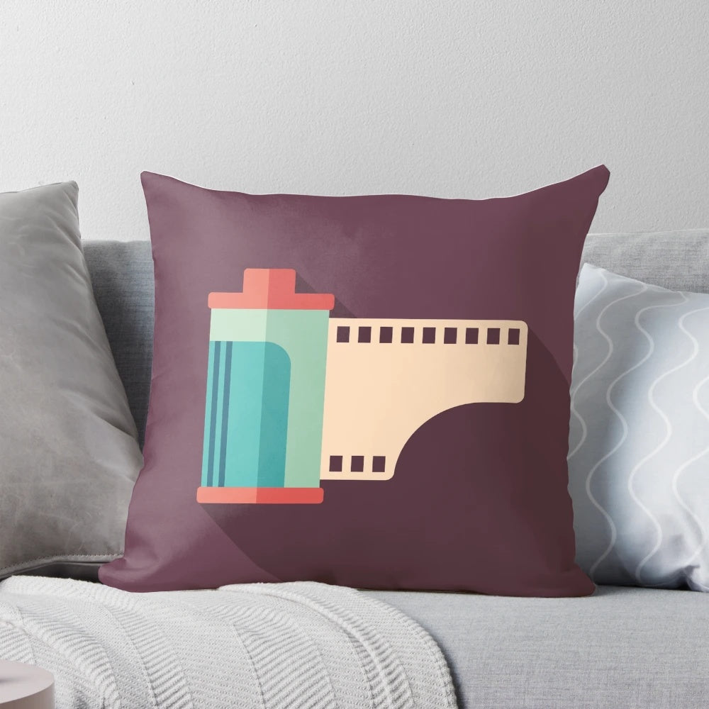 A pillow featuring a retro camera roll design, perfect for photography enthusiasts.