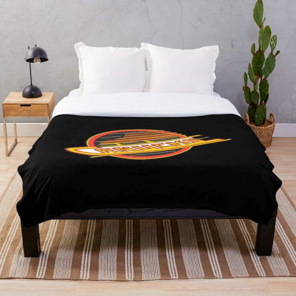Retro Canucks hockey plush blanket featuring the iconic team logo and colors