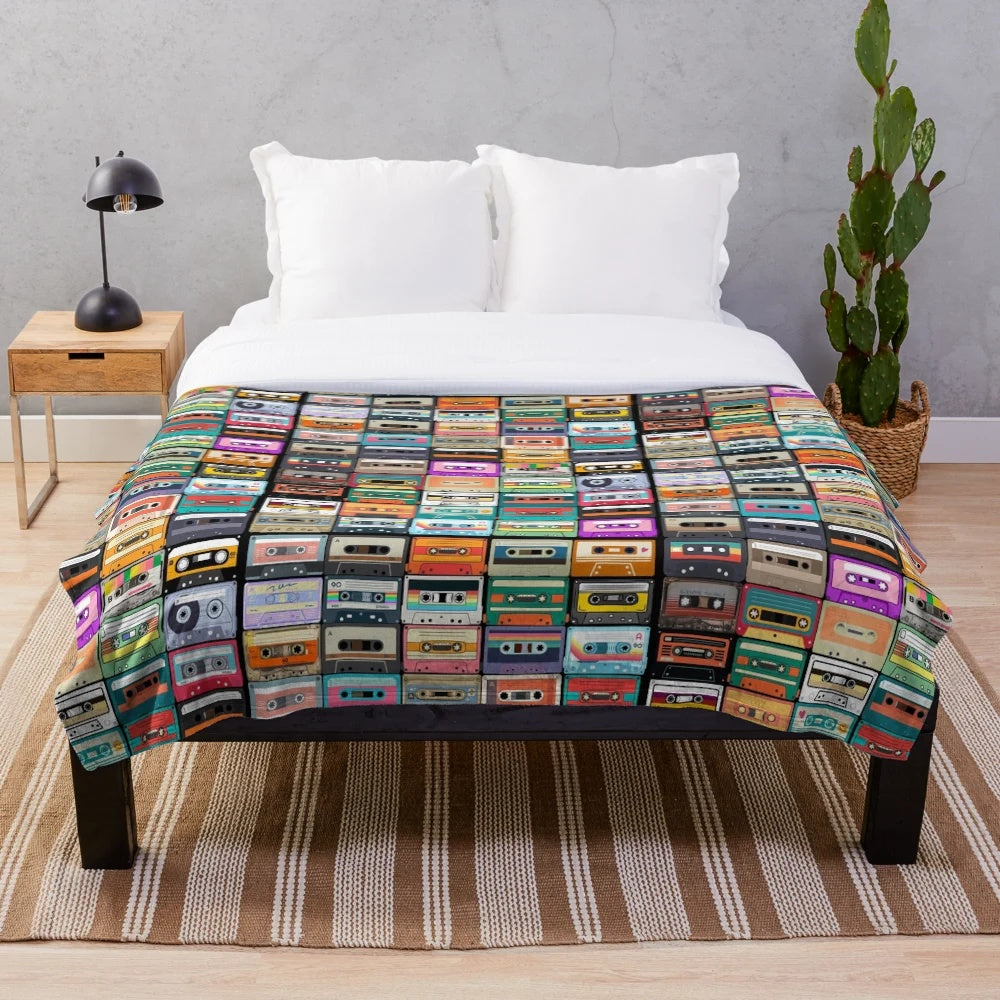 Cozy cassette tape plush blanket featuring a retro music design