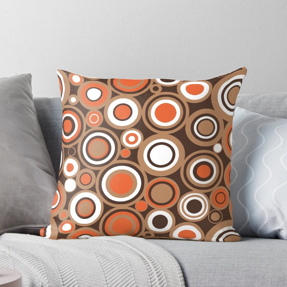 Retro circle pattern throw pillow in orange, white, and brown colors