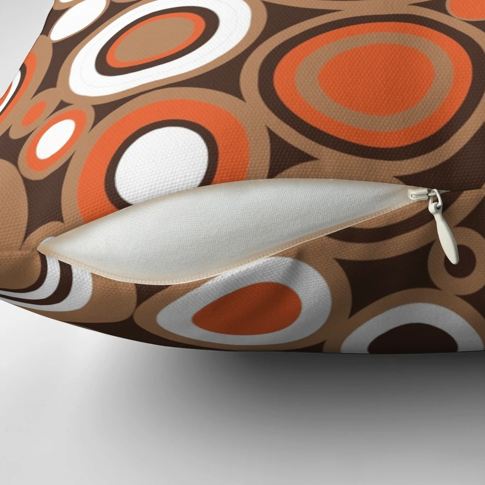 Retro circle pattern throw pillow in orange, white, and brown colors