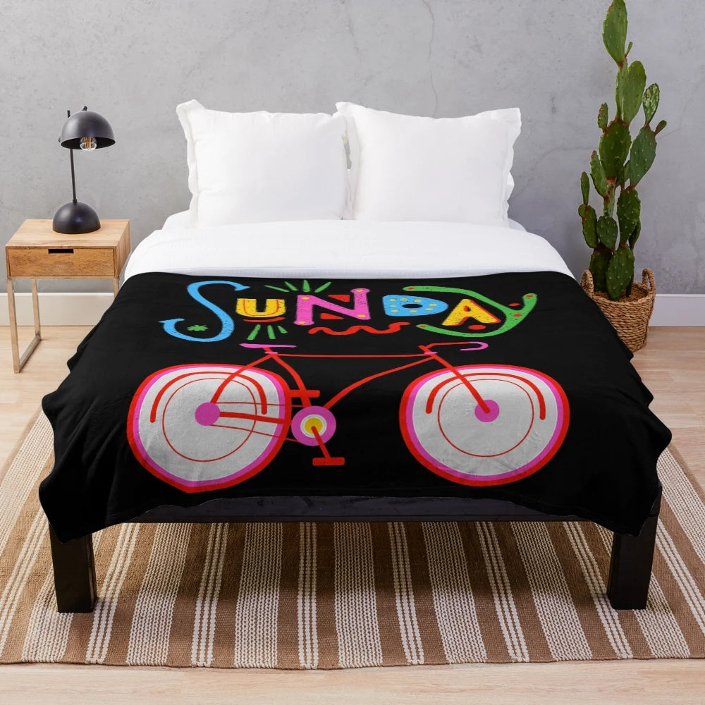 Retro-style plush blanket featuring a cycling design