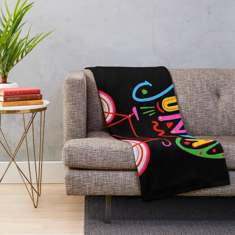 Retro-style plush blanket featuring a cycling design