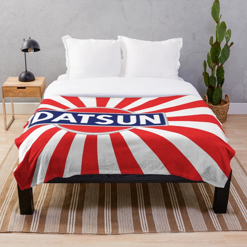 Vintage Datsun inspired plush blanket with retro automotive emblem