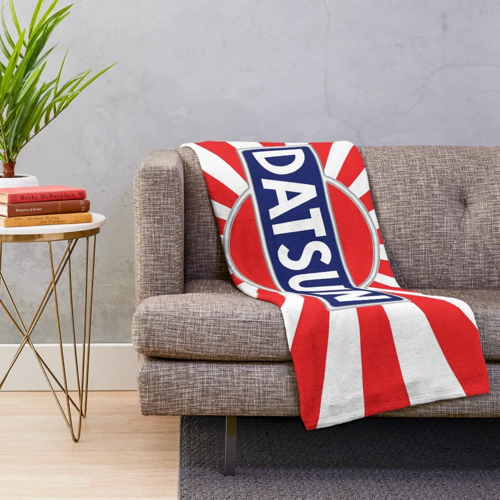 Vintage Datsun inspired plush blanket with retro automotive emblem