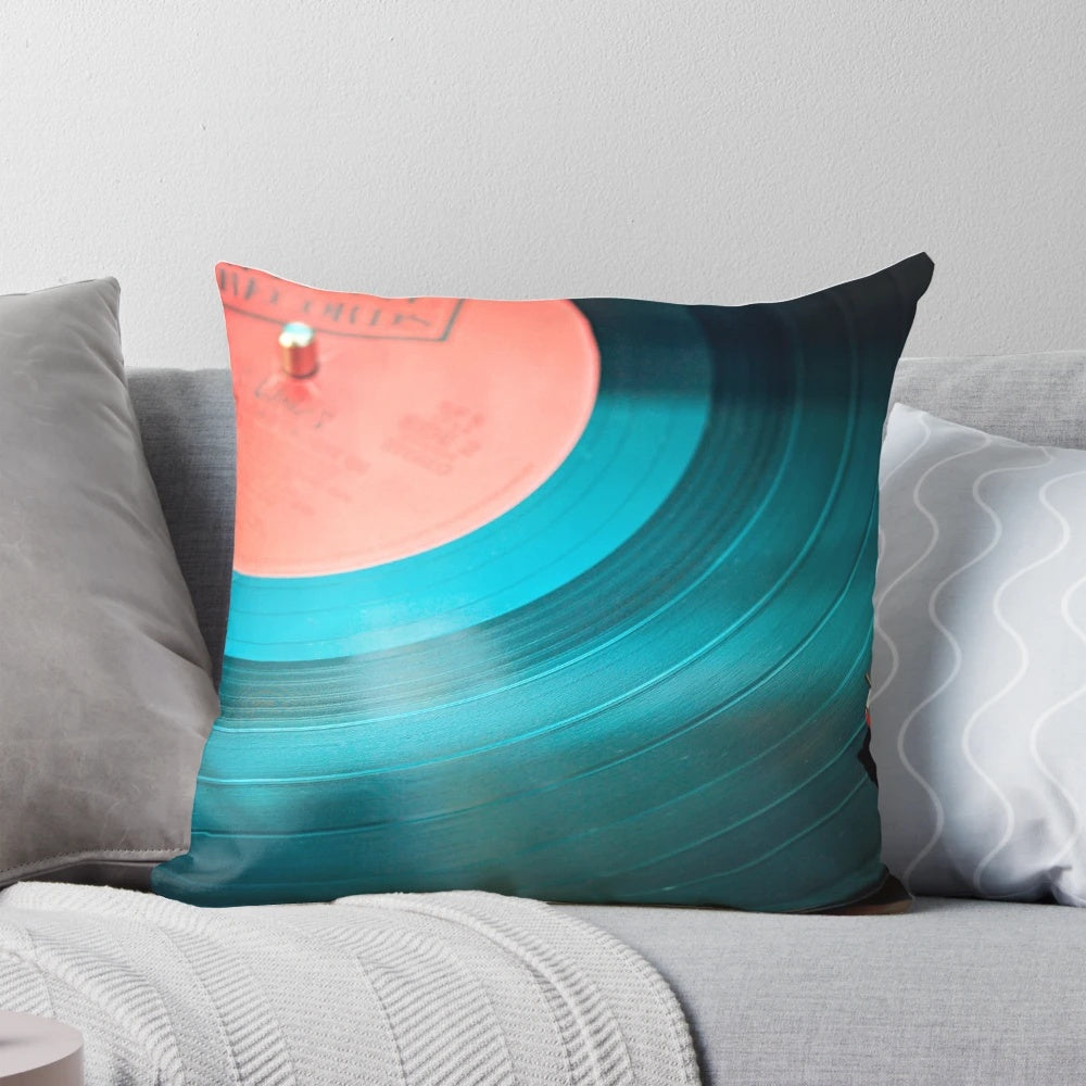 Soft, plush disk-shaped pillow inspired by vintage vinyl records for a retro music lover's home decor.
