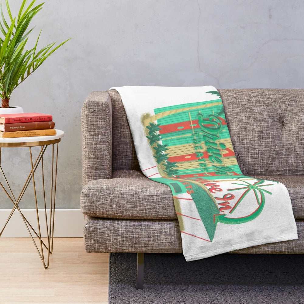 Plush blanket featuring a vintage drive-in theater design, perfect for a cozy movie night