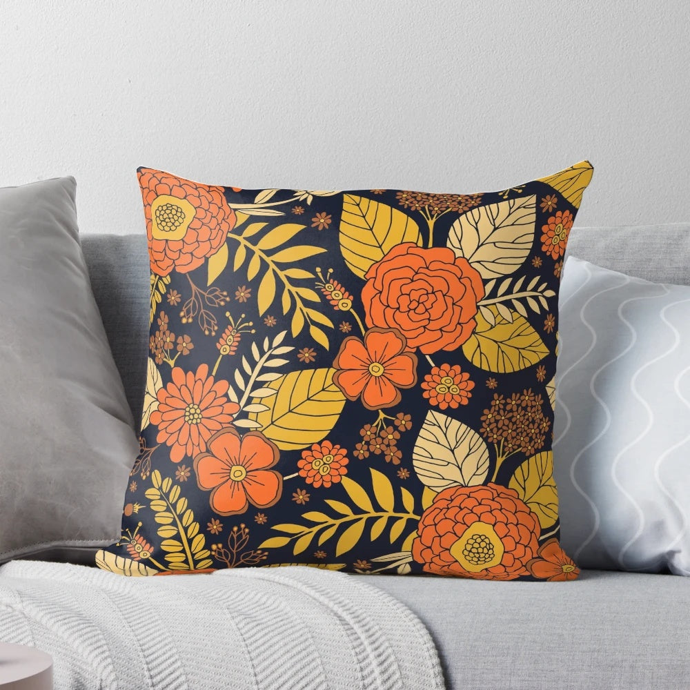 Retro floral 1970s pillow with a vintage flower and leaf design in shades of orange, yellow, brown, and navy.