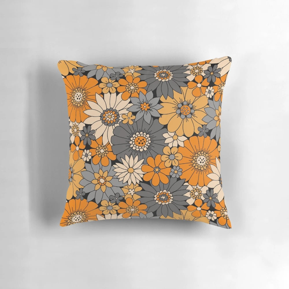 Retro floral Halloween pillow with orange, gray, and black daisies, dahlias, and mums