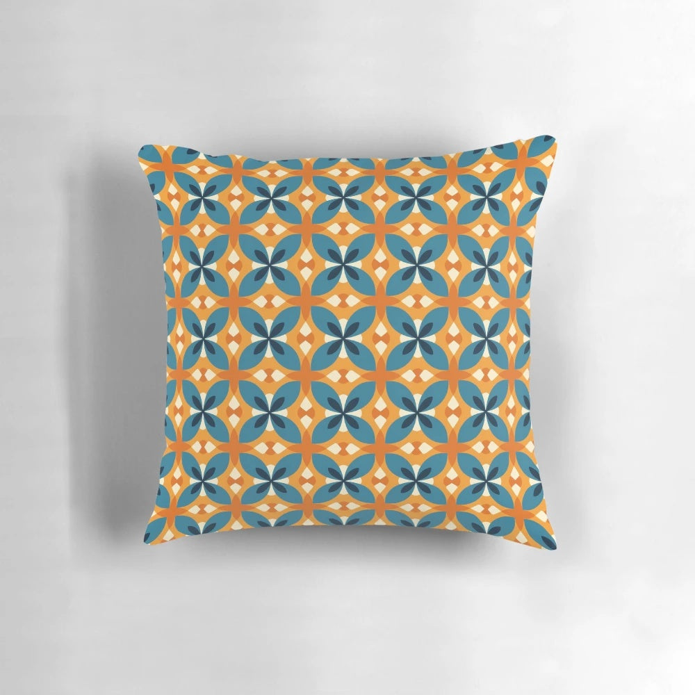 A blue and orange retro inspired floral pattern decorative pillow with a minimalistic, vintage aesthetic.