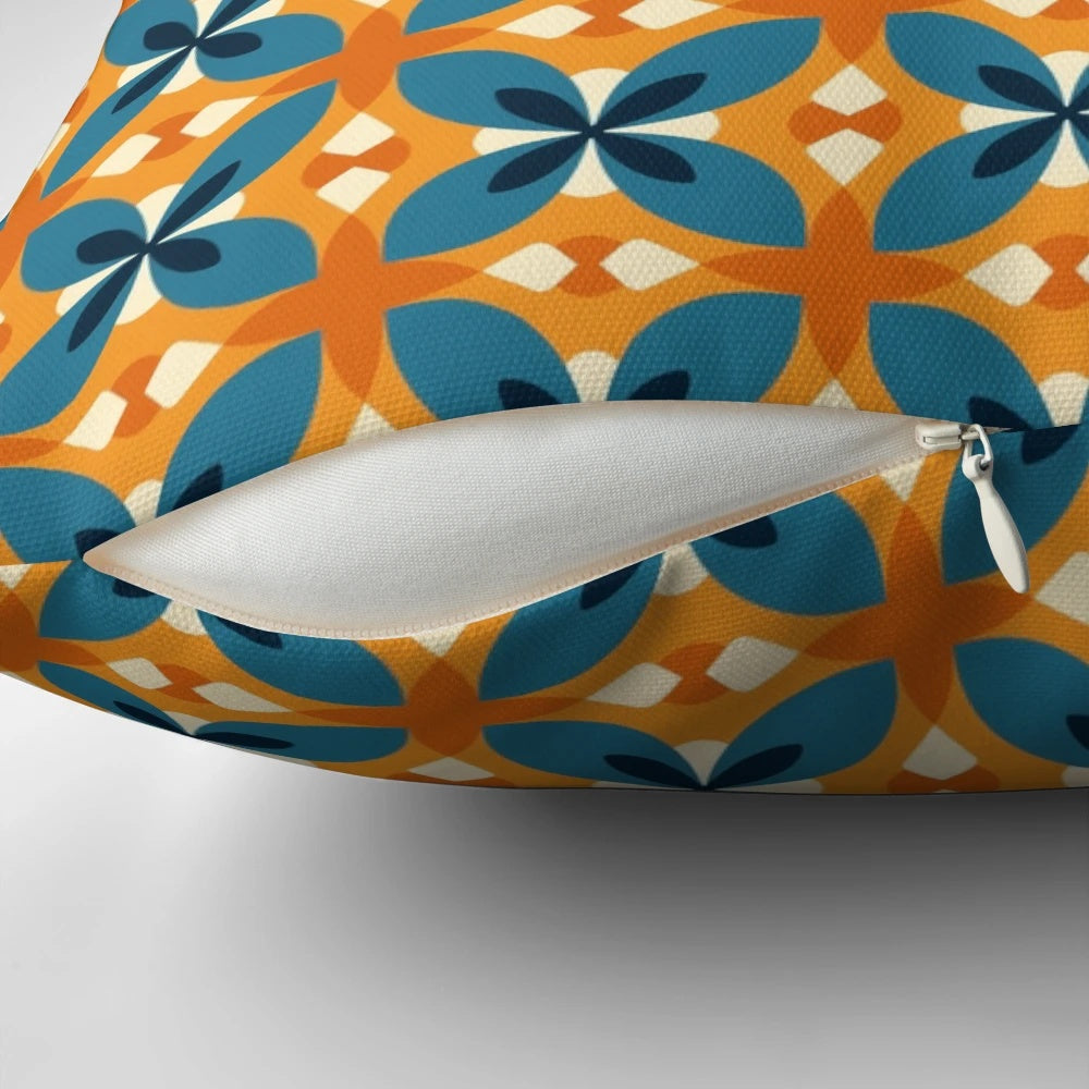A blue and orange retro inspired floral pattern decorative pillow with a minimalistic, vintage aesthetic.
