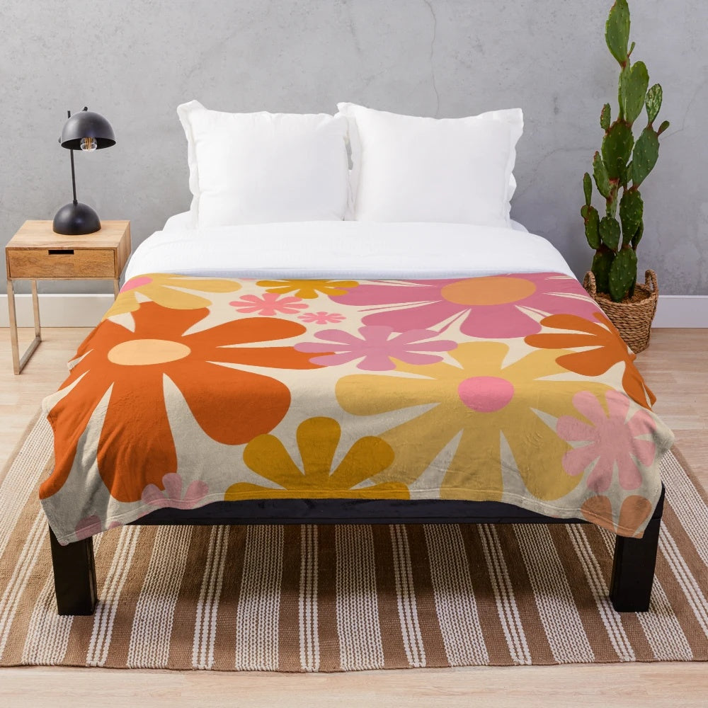 Retro floral pattern plush blanket in pink, orange, mustard, and cream