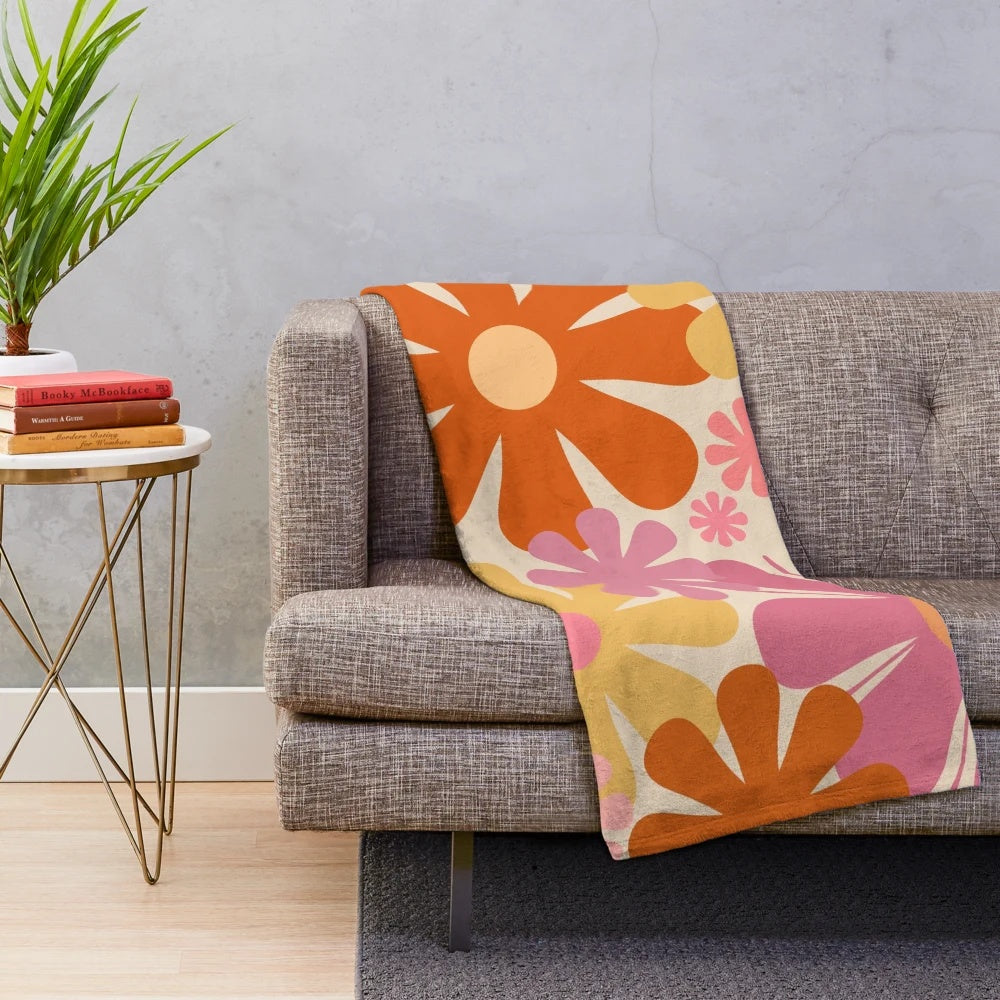 Retro floral pattern plush blanket in pink, orange, mustard, and cream