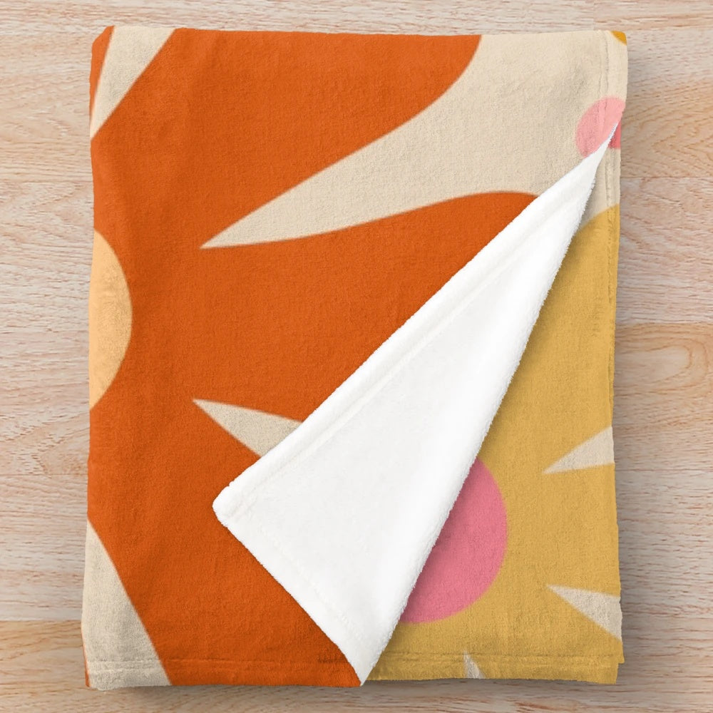 Retro floral pattern plush blanket in pink, orange, mustard, and cream