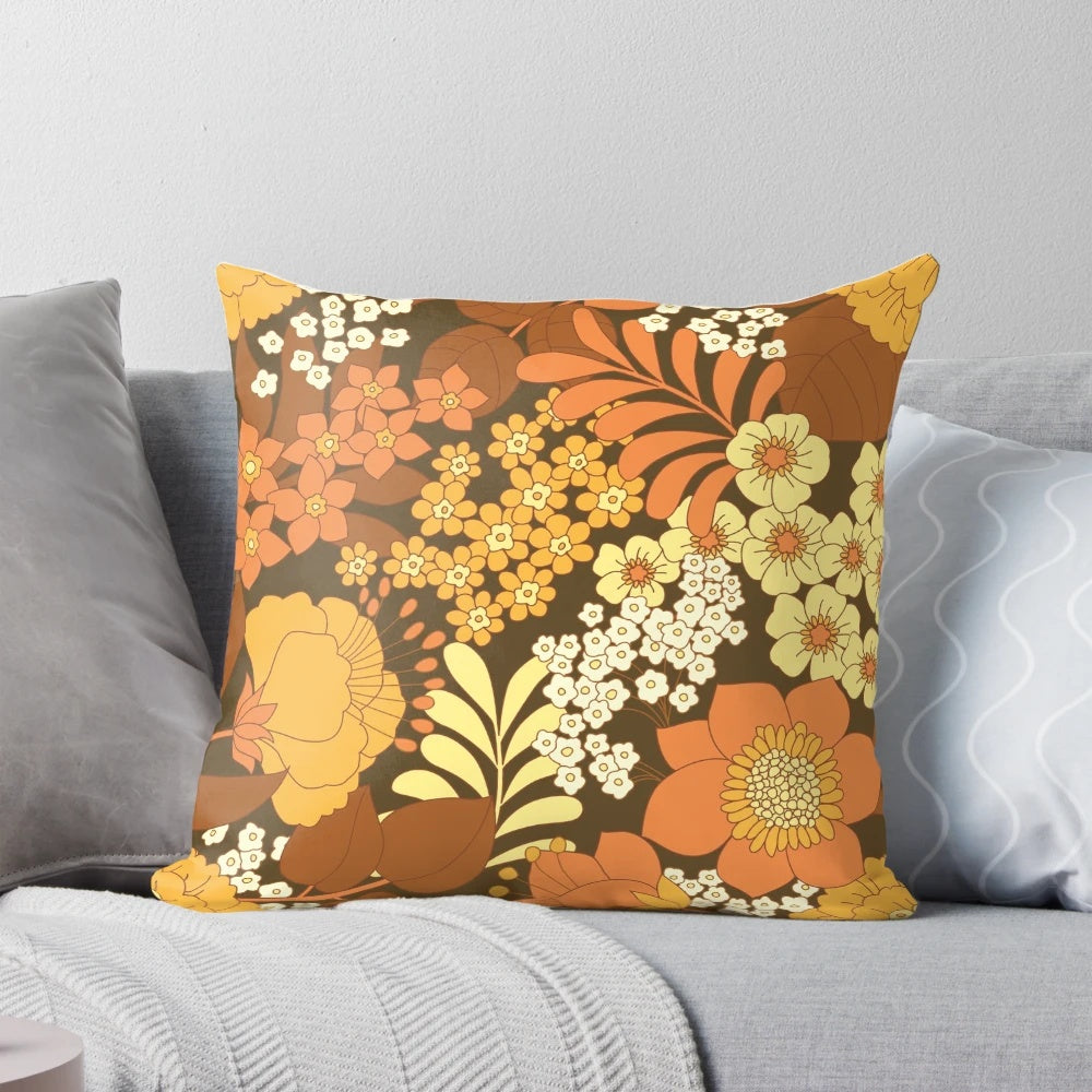 Colorful vintage-inspired floral pattern throw pillow in brown, yellow, orange, and ivory