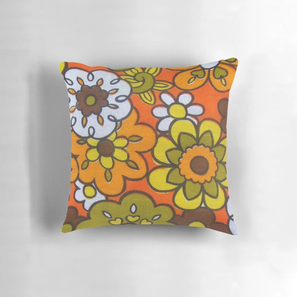 Vintage-inspired floral print pillow in avocado green, harvest gold, brown, and orange colors