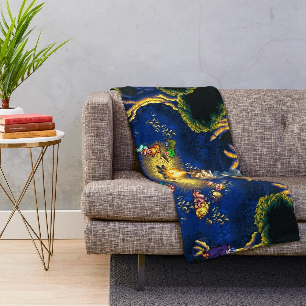 Retro gaming inspired plush blanket featuring Chrono Trigger pixel art campfire scene