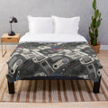 Plush blanket featuring a pattern of classic video game controllers