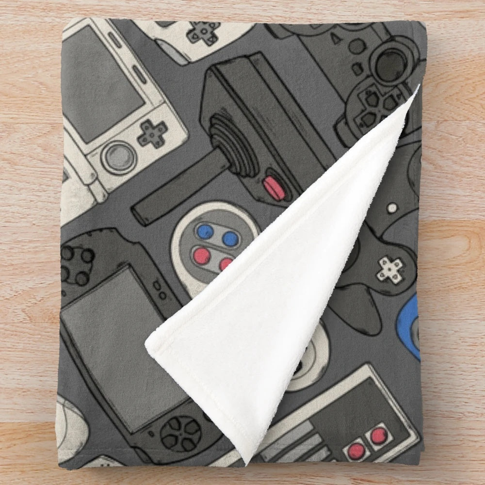 Plush blanket featuring a pattern of classic video game controllers