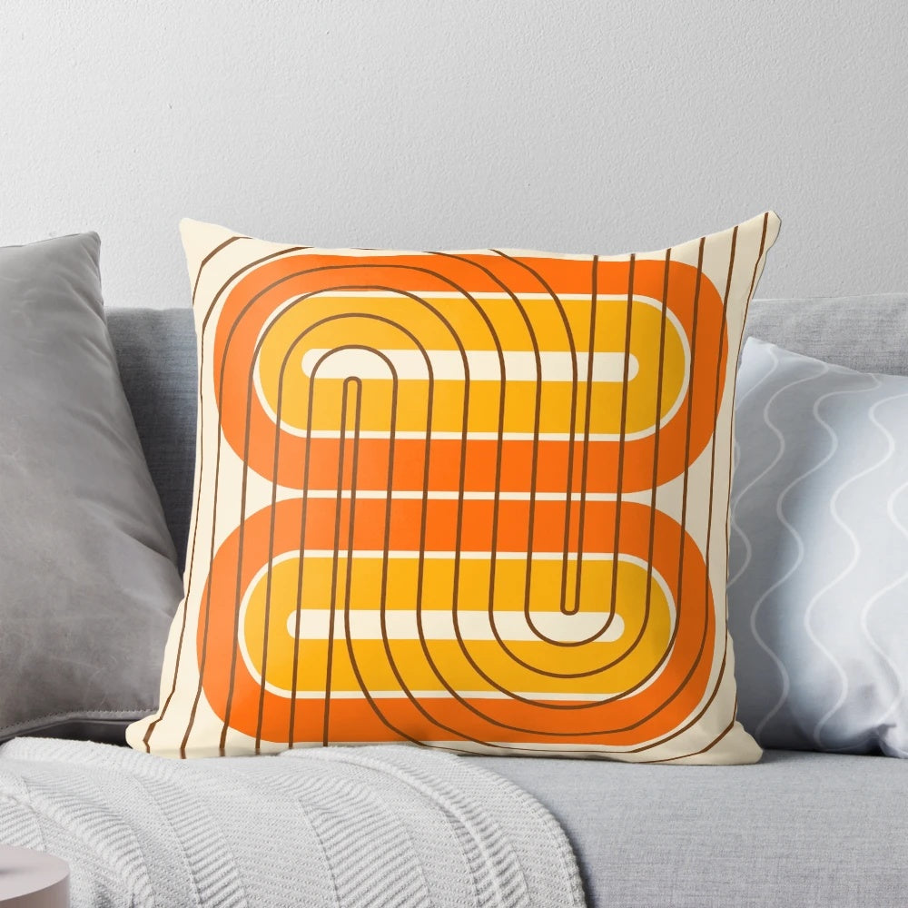 Vibrant retro geometric pattern pillow in orange, yellow, and brown tones for mid-century modern and 1970s inspired home decor.
