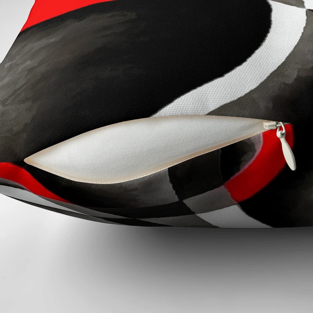 Throw pillow with a retro-inspired geometric pattern of intersecting curves in black, red, and white.