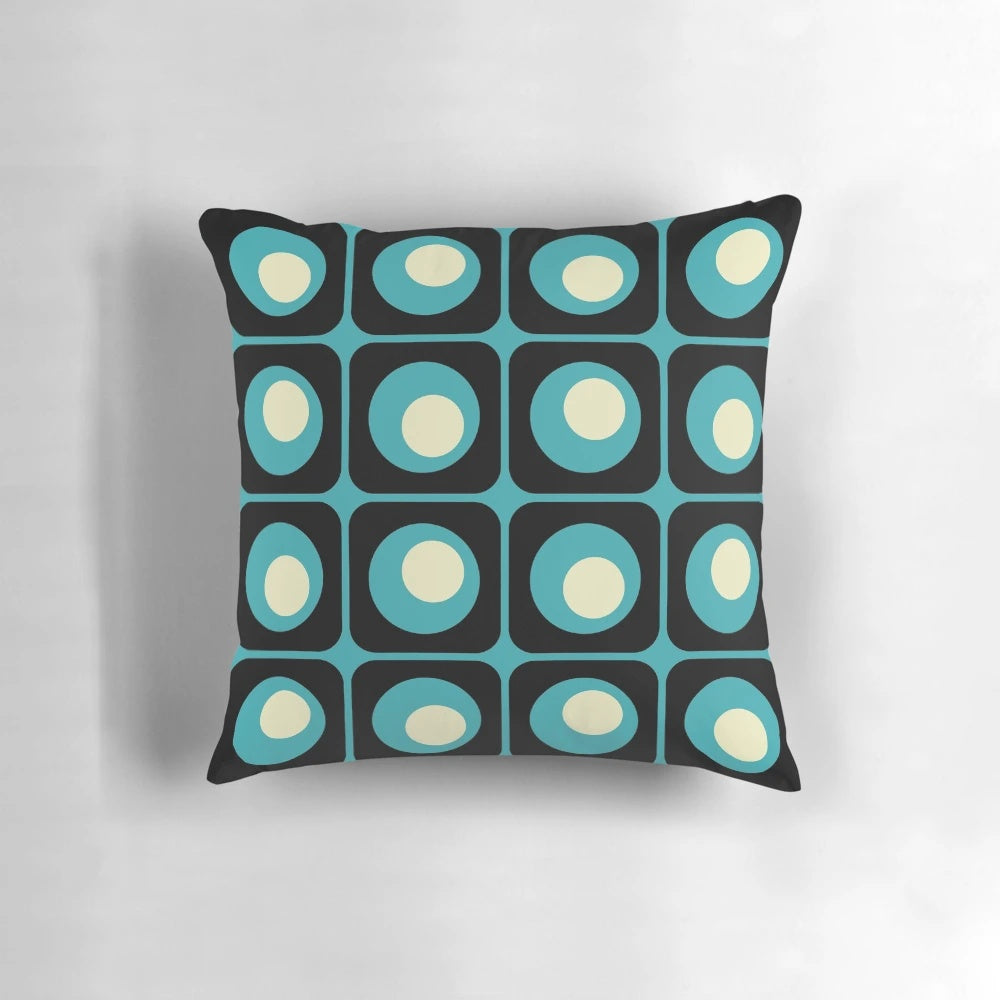 Retro geometric pillow with a vibrant gradient square and circle pattern in a midcentury modern style.