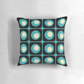 Retro geometric pillow with a vibrant gradient square and circle pattern in a midcentury modern style.